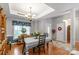 Bright dining room featuring hardwood floors, elegant chandelier, and lovely natural light at 2020 Olde Towne Dr, Monroe, NC 28110