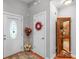 Bright foyer with hardwood floors, decorative doors, and an elegant wooden display cabinet at 2020 Olde Towne Dr, Monroe, NC 28110