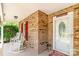 Cozy front porch with brick walls and white rocking chairs, offering a welcoming entrance at 2020 Olde Towne Dr, Monroe, NC 28110