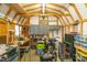 Well-lit garage with wooden beams, ample workspace, storage cabinets, and electrical outlets at 2020 Olde Towne Dr, Monroe, NC 28110
