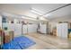 Spacious garage with ample storage cabinets, lighting, and a large door to the outside at 2020 Olde Towne Dr, Monroe, NC 28110