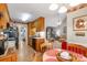 Open kitchen with wood cabinets, black appliances, and a view into the living room at 2020 Olde Towne Dr, Monroe, NC 28110