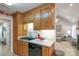 Kitchen area featuring wood cabinets and appliances; view leads into an open living area at 2020 Olde Towne Dr, Monroe, NC 28110