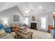 Bright living room featuring a fireplace, vaulted ceiling, and comfortable furniture arrangement at 2020 Olde Towne Dr, Monroe, NC 28110