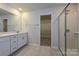 Bathroom featuring vanity, shower, tile flooring and access to a walk-in closet at 2206 Silverbell Ln, Stanley, NC 28164