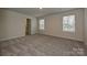 Carpeted bedroom with closet, two windows, and neutral colored walls provides great light at 2206 Silverbell Ln, Stanley, NC 28164
