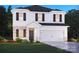 New two-story home with brick accents, a two-car garage, and professionally landscaped front yard at 2206 Silverbell Ln, Stanley, NC 28164