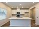 Bright kitchen with white cabinets, quartz countertops, stainless steel appliances, and island at 2206 Silverbell Ln, Stanley, NC 28164