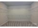 Carpeted walk-in closet with wire shelving for ample storage and organization at 2206 Silverbell Ln, Stanley, NC 28164