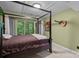 Bedroom features tile floors, a four-poster bed, and sliding glass doors leading to the backyard at 222 Riverview Ter, Clover, SC 29710