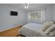 Light-filled bedroom features hardwood floors, a ceiling fan, and large window at 222 Riverview Ter, Clover, SC 29710