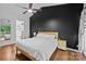 Modern bedroom features hardwood floors and an en-suite bathroom with natural light from the exterior at 222 Riverview Ter, Clover, SC 29710