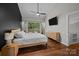 Modern bedroom with hardwood floors, a ceiling fan, and a mounted television for comfortable living at 222 Riverview Ter, Clover, SC 29710