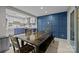 Inviting dining area with a large wooden table, modern lighting, and blue accent walls creates a stylish space at 222 Riverview Ter, Clover, SC 29710