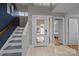 Welcoming foyer with a glass-paneled front door and stairs leading to upper level at 222 Riverview Ter, Clover, SC 29710
