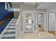Bright foyer with modern door, staircase, and neutral decor creates a welcoming entrance and complements the home's design at 222 Riverview Ter, Clover, SC 29710
