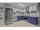 Updated kitchen features stainless steel appliances, white cabinets, and blue base cabinets at 222 Riverview Ter, Clover, SC 29710