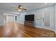Spacious living room featuring hardwood floors, a modern TV, and access to the lower level at 222 Riverview Ter, Clover, SC 29710