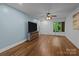 Spacious living room boasts hardwood floors and a streaming TV in a partially finished basement at 222 Riverview Ter, Clover, SC 29710