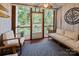 Inviting sunroom with wood floors, white furnishings, and serene views of the surrounding greenery at 222 Riverview Ter, Clover, SC 29710