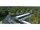 Aerial view of covered boat docks on the lake surrounded by lush green forest at 27037 Tidal Way, Tega Cay, SC 29708