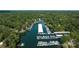 Aerial view of covered boat docks on the lake surrounded by lush green forest at 27037 Tidal Way, Tega Cay, SC 29708