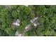 Aerial view showcasing a home nestled among lush trees, featuring a pool and serene surroundings at 27037 Tidal Way, Tega Cay, SC 29708
