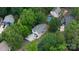 An aerial view of a charming home nestled among lush trees, offering a serene and private setting at 27037 Tidal Way, Tega Cay, SC 29708