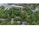 Aerial view of a home near the lake and marina nestled in a lush green forest at 27037 Tidal Way, Tega Cay, SC 29708