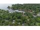 Aerial view of a home near the lake and marina nestled in a lush green forest at 27037 Tidal Way, Tega Cay, SC 29708