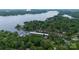 Scenic aerial view of lakefront community with boat docks nestled in dense forest at 27037 Tidal Way, Tega Cay, SC 29708