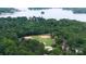 An elevated aerial view of the baseball field situated within a stunning backdrop of a dense tree line and lake at 27037 Tidal Way, Tega Cay, SC 29708