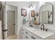 Bright bathroom featuring a double sink vanity with black fixtures and arching mirrors at 27037 Tidal Way, Tega Cay, SC 29708