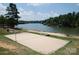 Beach volleyball court set on the sandy shore with a serene lake view for active residents at 27037 Tidal Way, Tega Cay, SC 29708