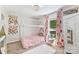 Cozy bedroom with a pink bed frame, floral curtains, and a soft white rug at 27037 Tidal Way, Tega Cay, SC 29708