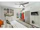 Bedroom featuring a decorative fireplace, ceiling fan, closet, and mounted tv at 27037 Tidal Way, Tega Cay, SC 29708