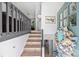Light filled entry features decorative wreath, stairwell, and laminate flooring at 27037 Tidal Way, Tega Cay, SC 29708