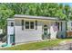 Charming home featuring gray shutters, front door wreath, and a level yard at 27037 Tidal Way, Tega Cay, SC 29708