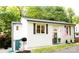 Charming white exterior with green door, flag, and lovely landscaping at 27037 Tidal Way, Tega Cay, SC 29708