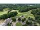 An aerial view of the golf course, showcasing its lush fairways, putting greens, and beautiful lakeside community at 27037 Tidal Way, Tega Cay, SC 29708