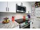 Modern kitchen showcasing stainless steel appliances, white cabinetry and granite countertops at 27037 Tidal Way, Tega Cay, SC 29708