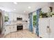 Well-lit kitchen showcasing stainless steel appliances, white cabinets, granite countertops, and lots of natural light from the window at 27037 Tidal Way, Tega Cay, SC 29708