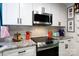 Modern kitchen showcasing stainless steel appliances, white cabinetry and granite countertops at 27037 Tidal Way, Tega Cay, SC 29708