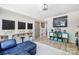 Finished basement with a blue sofa, workspace, TV, and brick accent wall at 27037 Tidal Way, Tega Cay, SC 29708