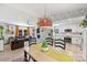 Bright, open-concept living room and kitchen area with a large dining table, stainless steel appliances, and ample natural light at 27037 Tidal Way, Tega Cay, SC 29708