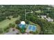 A high aerial view highlighting the tennis courts, water tower and surrounding lush landscape at 27037 Tidal Way, Tega Cay, SC 29708