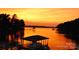 Sunset view overlooking the calm lake and a covered dock perfect for relaxing evenings at 27037 Tidal Way, Tega Cay, SC 29708