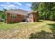 Backyard view featuring a patio with seating and a well-maintained lawn at 2804 Pulaski Dr, Monroe, NC 28110