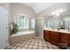Bathroom with a soaking tub, tiled floors, glass shower and brown cabinets at 2804 Pulaski Dr, Monroe, NC 28110
