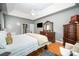 Bedroom features a wooden bed frame, dresser, a TV and gray accent rug at 2804 Pulaski Dr, Monroe, NC 28110
